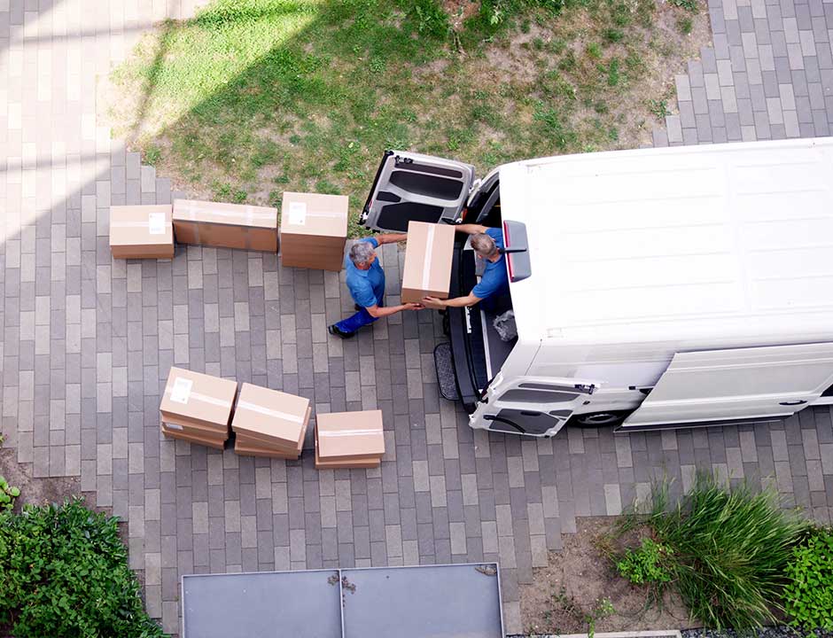 Aerial view of a removals team loading boxes into a van for a house clearance